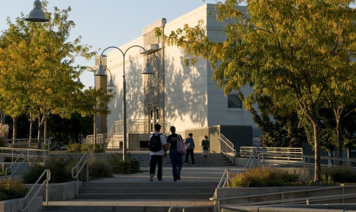 Students walk by a campus building